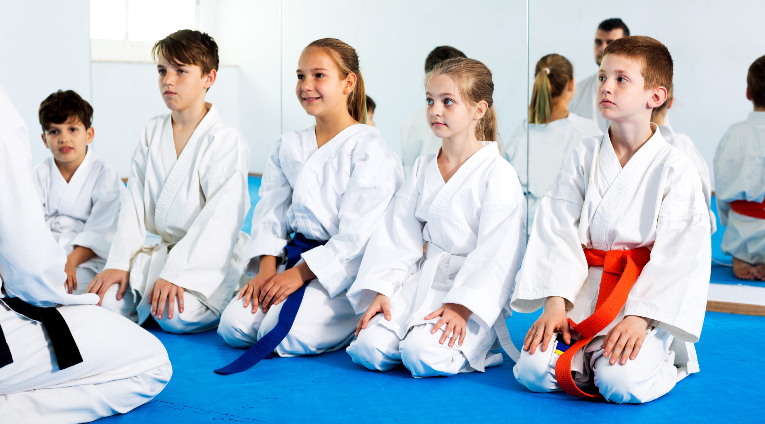 Children enjoying their trainings with coach at karate