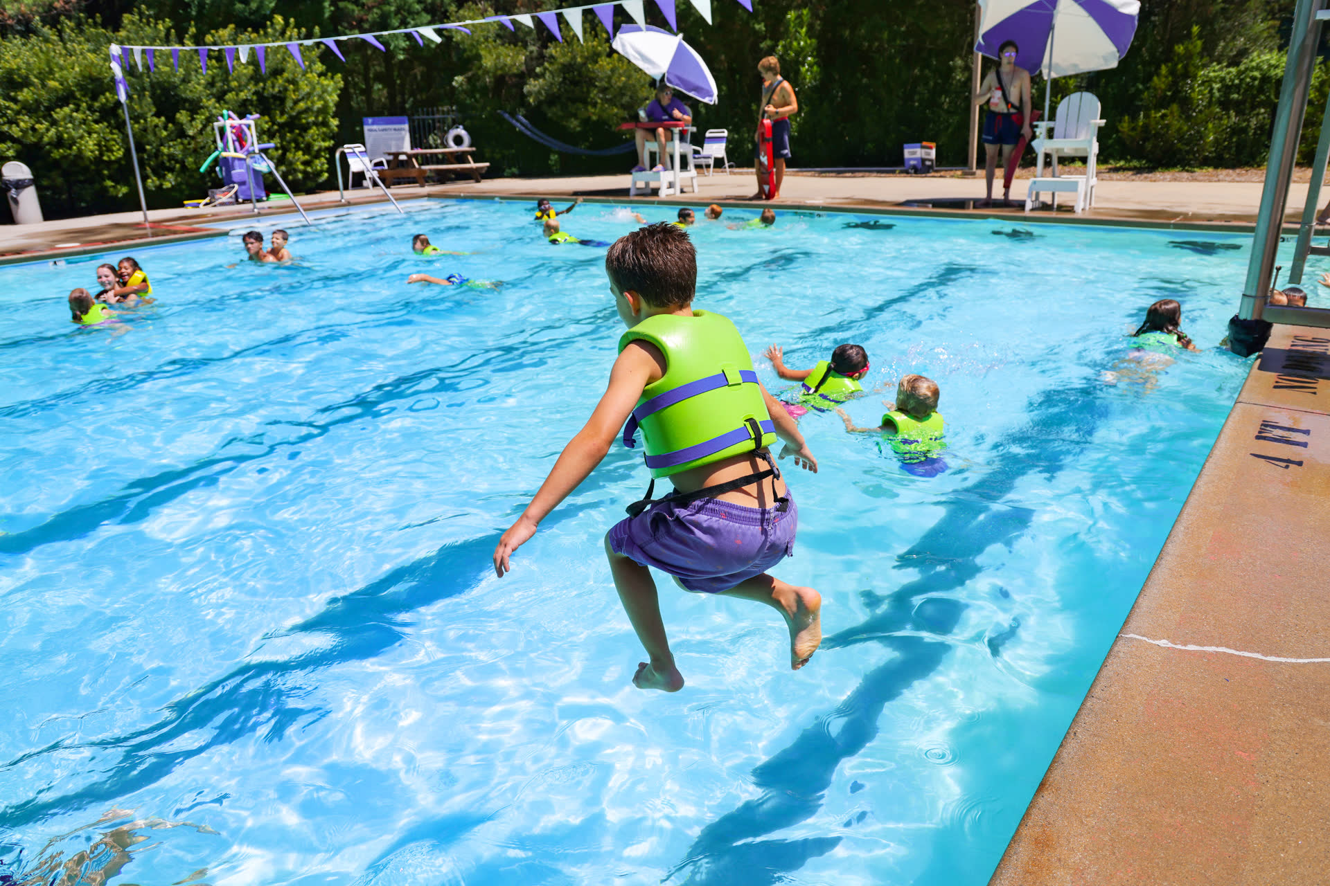 Child jumping into a pool