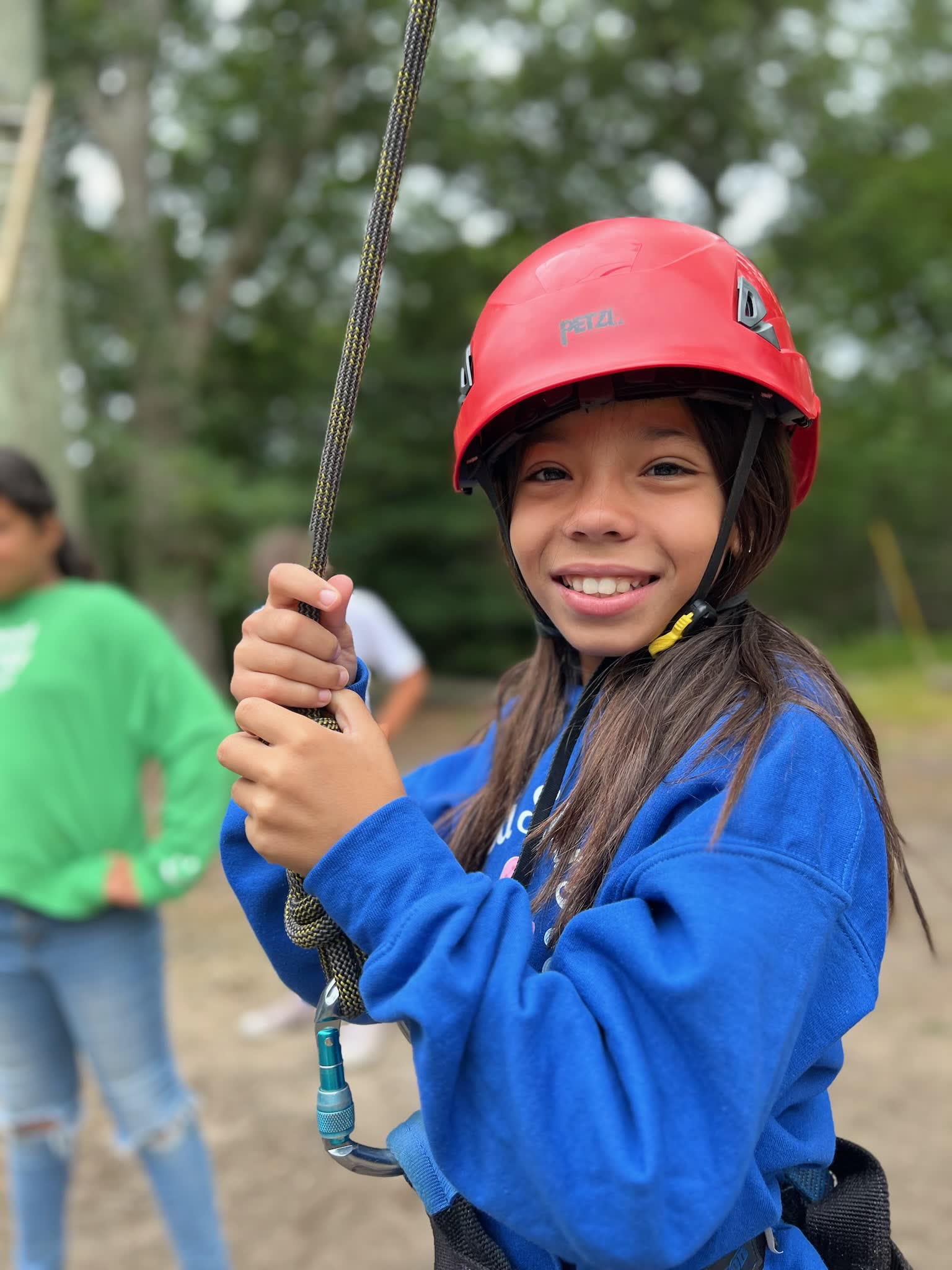 A YMCA member holding a zip line rope at summer camp