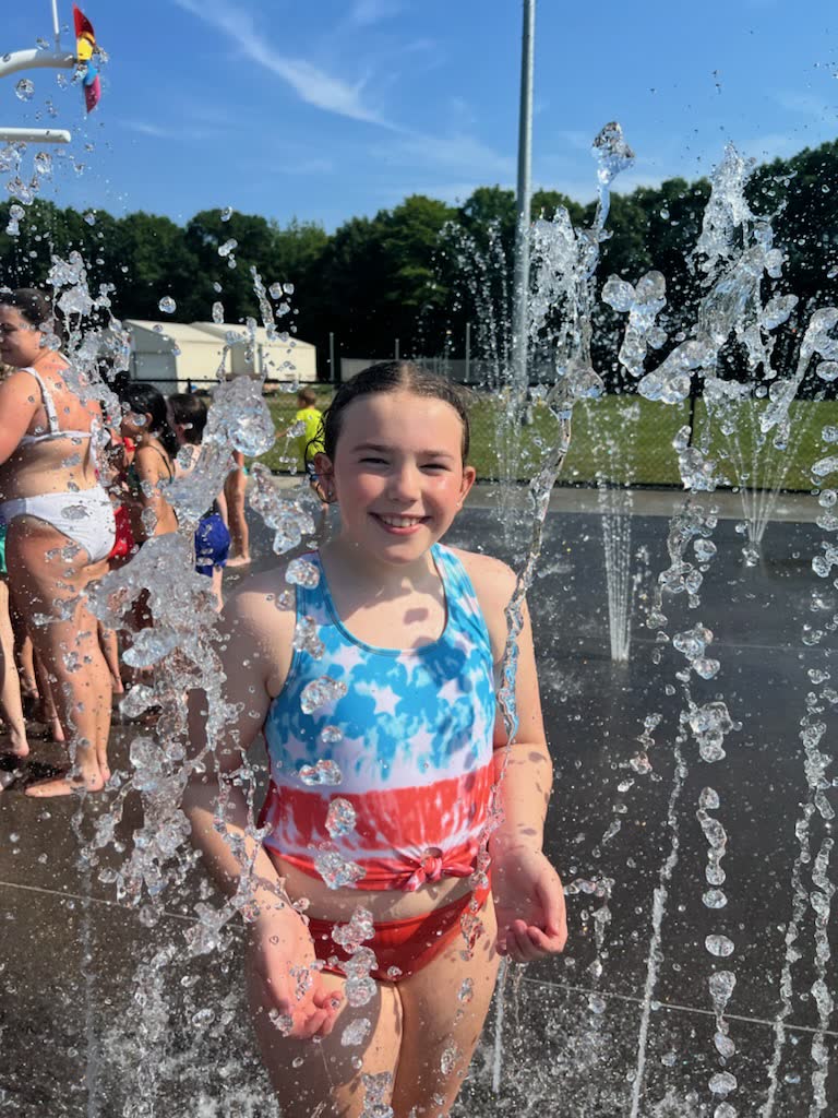 A child enjoying a water fountain