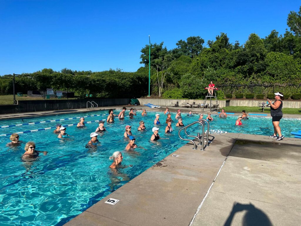 Dartmouth YMCA outdoor pool filled with a group of swimmers participating in a class