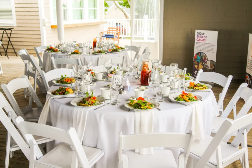 YMCA Southcoast annual meeting table with salads in front of each chair