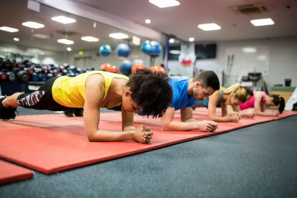 YMCA members planking on yoga mats