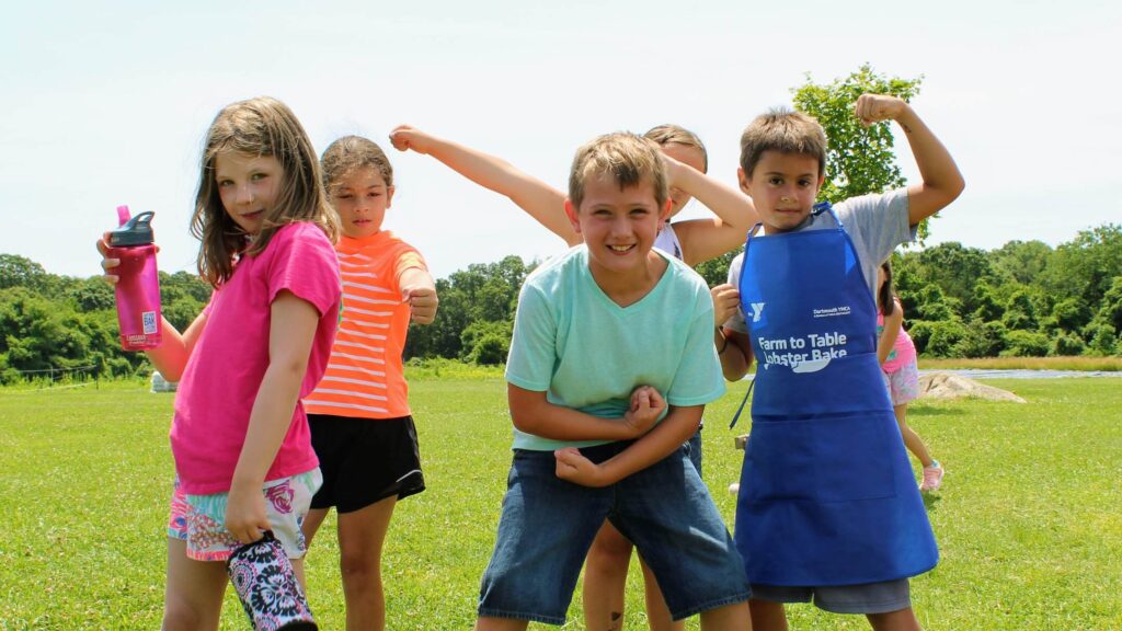 School aged children posing for the camera at Summer Day Camp