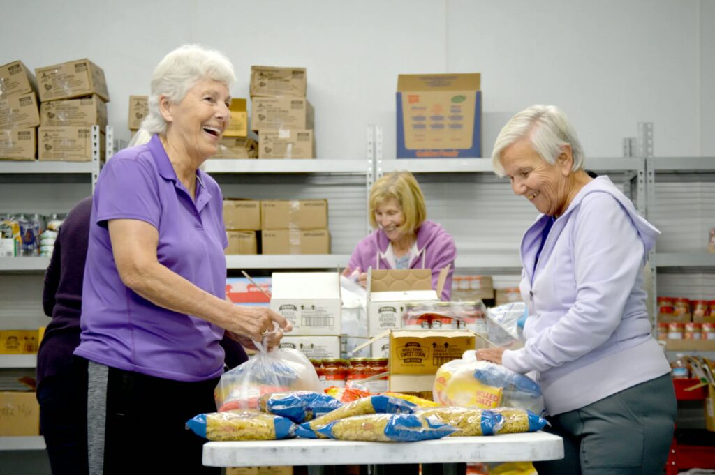 Volunteers at YMCA Southcoast preparing food